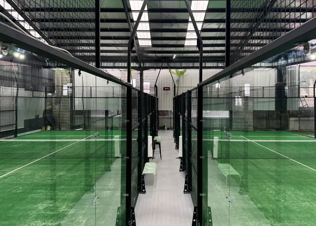 Two courts side by side with a walkway between