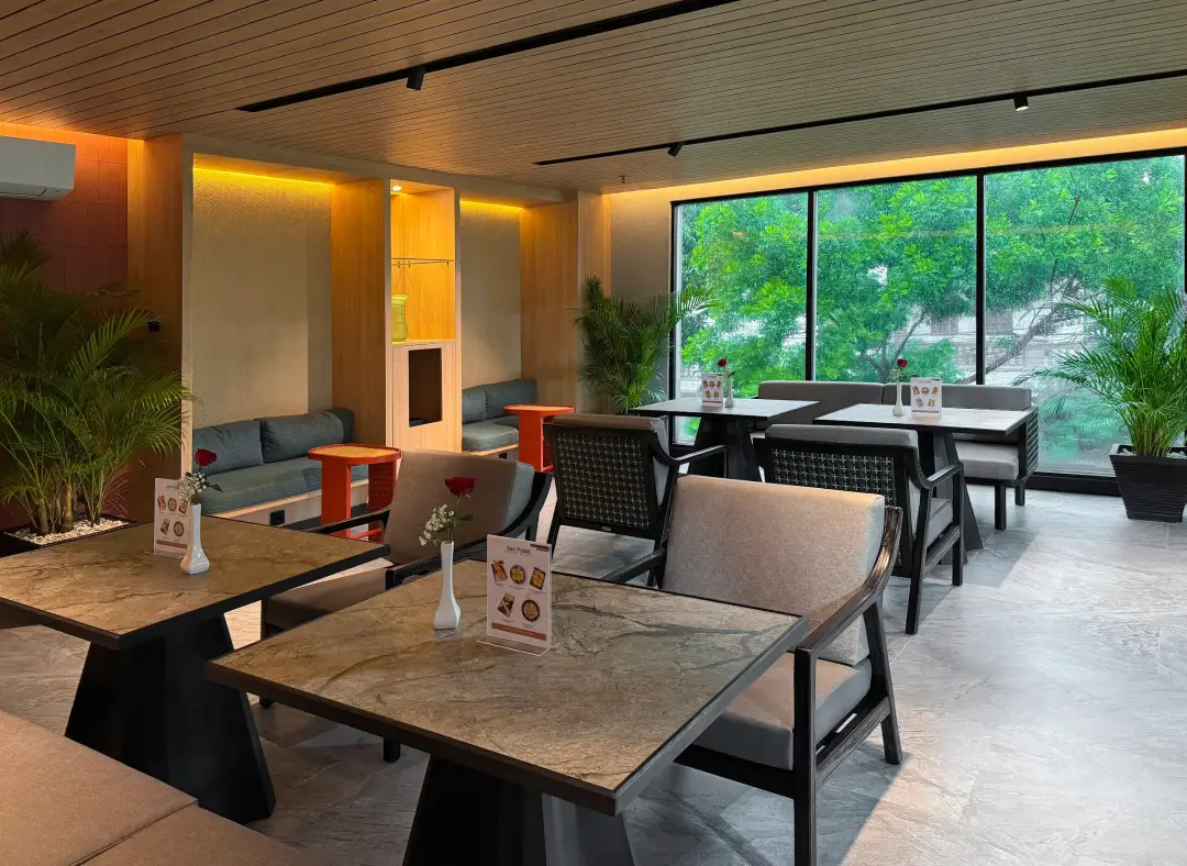 Lounge with marble tables, leather chairs and greenery