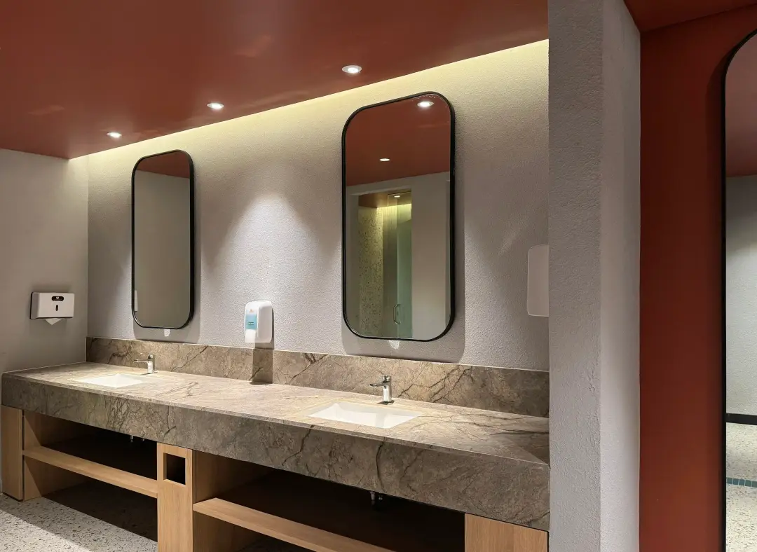 Restroom vanity with arched mirrors