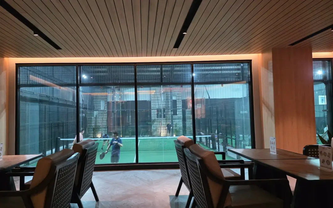 Lounge looking through glass onto the court